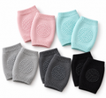 Baby knee pads shown in pink, teal, grey, charcoal, and black